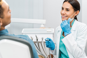 Dentist smiling at patient in treatment chair