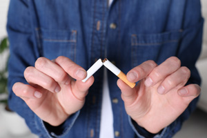 Patient in denim jacket breaking cigarette