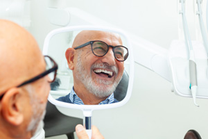 Man with black glasses smiling in reflecton