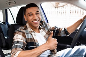 Man smiles in car