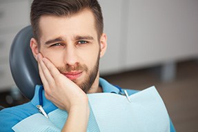 Bearded man with toothache in dental chair