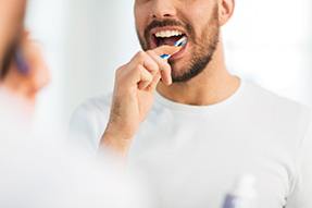 Close-up of bearded man brushing his teeth